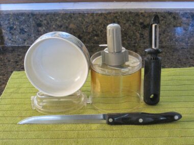 Kitchen utensils on a green cloth.