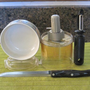Kitchen utensils on a green cloth.