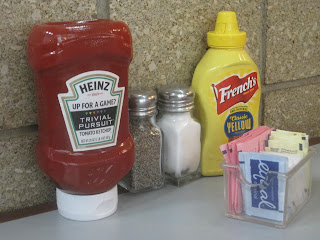 Condiments and sweeteners on restaurant table.