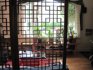 Decorative room divider with plants and furniture.