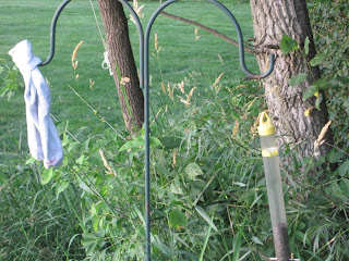 Bird feeder and cloth on metal stand.