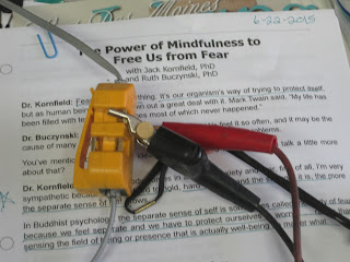 Paper with clips and electrical connectors.