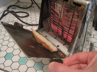 Vintage toaster with bread being toasted.