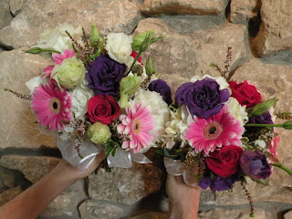 Colorful flower bouquet against stone wall background.