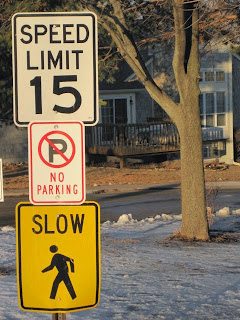 Speed limit and no parking signs.