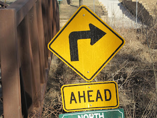 Left turn ahead road sign.