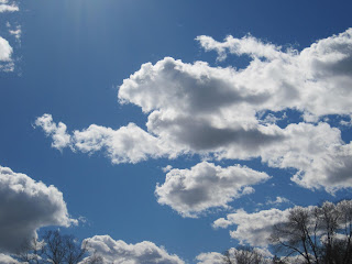 Fluffy white clouds in blue sky.