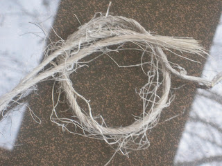 Frayed rope on a textured surface.