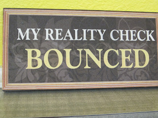 Sign with humorous text about reality checks.
