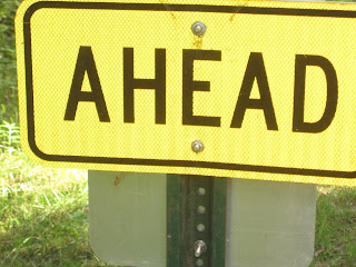 Yellow sign with the word "AHEAD".