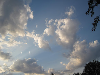 Cloudy sky with scattered sunlight rays.