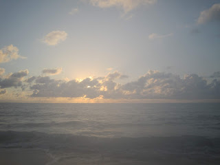 Sunset over the ocean with clouds.