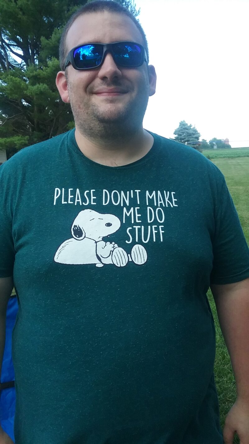 Person wearing a humorous Snoopy T-shirt about avoiding tasks.